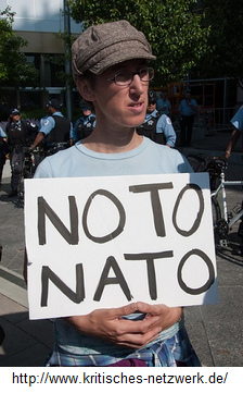 Truth 11 about NATO: Demonstration
                              in the "USA" with a poster
                              Plakat "NO TO NATO"
