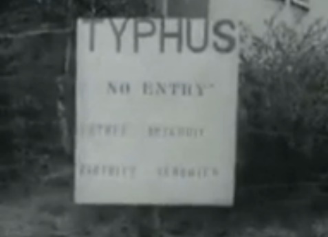 Board in English with the claim
                    "typhus" in the concentration camp of
                    Bergen-Belsen (18min. 4sec.)