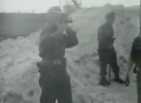 A cameraman
                                        is filming the SS men how they
                                        are taking the bodies to the
                                        mass grave (15min. 12sec.)