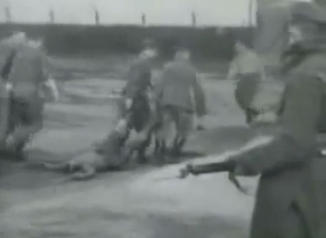 Bodies are torn on the floor by SS men
                          02, guarded by a guard with a bayonet, the
                          clothes are NO uniforms from German
                          concentration camps, and there are NO tattooed
                          numbers on the bodies and NO remnants of earth
                          at the bodies can be seen