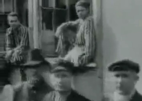 Captives in the cc Dachau,
                detainees sitting in a window