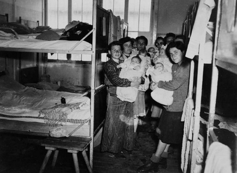 Liberated
                        women in the Dachau concentration camp with new
                        born children, in good health