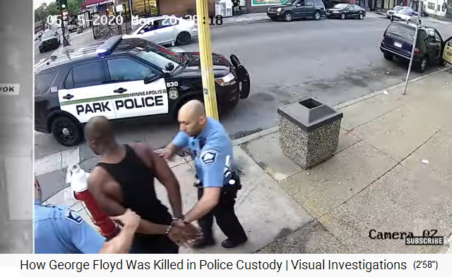 Floyd is walking in handcuffs
                        to the police car