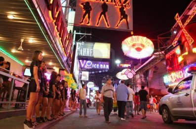 Pattaya, Walking Street with
              public bars, Thailand, with a file of prostitutes making
              offers for tourists, 2011