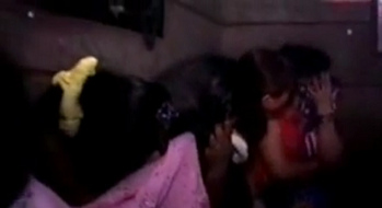 Secret
                      brothel in Mumbai in India, prostitutes protecting
                      their face