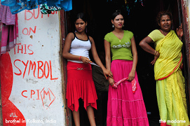 Brothel in Calcutta, 3 prostitutes waiting
                      for customers