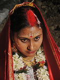 Woman in India with
                          a sindoor (red powder) in the middle of her
                          hair