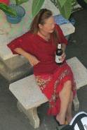 Pattaya, ex prostitute, an alcoholic
                        without end with a beer bottle near SY mansion