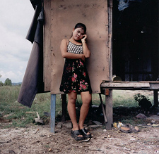 Kimi, about
                                  16 years old, on Kho Kong Island
                                  "chicken farm" with her
                                  little house