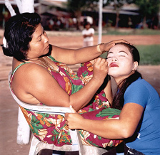 Koh Kong
                                  Island, brothel chicken farm in the
                                  village of Stung, brothel boss
                                  (mama-san) painting a prostitute girl