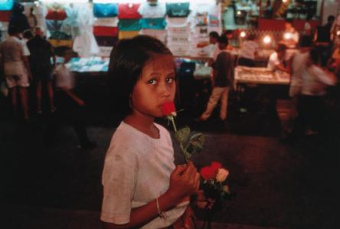 Burmese girl Kham Suk was sold by her parents to a
              brothel in Thailand for 80 "US" dollars - and is
              selling flowers here