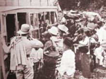 Javanese settlers boarding a bus to a new
                          transmigration colony in Lampung, late 1930s.