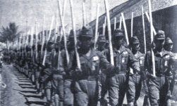 Indonesian
                    "heiho" soldiers train with wooden staffs
                    instead of weapons, 1943