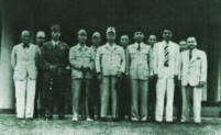 Sukarno poses with
                    Japanese military and civilian officials in Ujung
                    Pandang in April 1945.