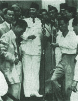 Sukarno at the microphone on August 17,
                          1945