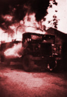 Dutch vehicle in flames
                    after a guerilla ambush at Puncak, April 1947.