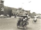 Street scene, Jakarta, 1965. The banner [in
                      the background] says "45 TAHUN PKI" (45
                      Years of the PKI)