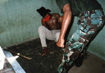 East Timor:
                    torture by Indonesian troops 07, blindfold, gag and
                    bamboo stick