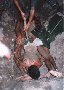 East Timor: torture by Indonesian troops 08,
                    killed victims are put into a superficial grave