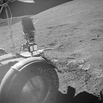 Alunizaje falso de Apolo 15, foto de la
                          NASA no. AS15-85-11494: una rueda delantera
                          del "carro lunar" en la sombra
                          aclarada, y la rueda est mal, y hay pisadas
                          de saltos