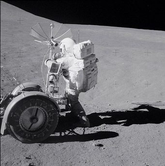 Alunizaje falso de Apolo 15, foto de la
                        NASA no. AS15-90-12219: el
                        "astronauta" Scott trabajando con la
                        cmara de tele del "carro lunar"