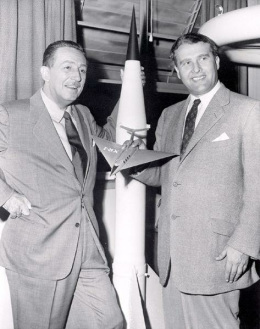 1955: Walt Disney (left) and Wernher von
                          Braun (right) with a model of Hitler's V2
                          rocket, Braun with an airplane model in his
                          hand.