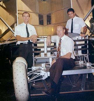 Foto no. 70-HC-911: The three
                            astronauts Scott, Worden and Irwin on a
                            model of a "moon car" called
                            "Rover"