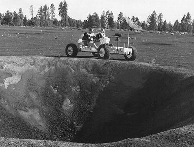 Irwin (left) and Scott (right) with the
                            training "moon car"
                            "Grover" (Lunar Roving Vehicle
                            Simulator, "1g trainer") on a
                            geological excursion in the crater field of
                            Cinder Lake, Arizona, at a border of a 30
                            feet deep crater, 2.-3. November 1970, Foto
                            1.