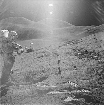 Faked moon landing Apollo 15
                        photo no. AS15-85-11515: Station 6 with Irwin on
                        the slope, tow Suns in the sky and Rover in the
                        background