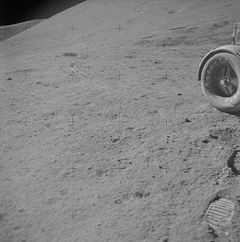 Faked moon landing Apollo 15 photo no.
                        AS15-90-12215: Impossible wheel tracks with back
                        wheel.