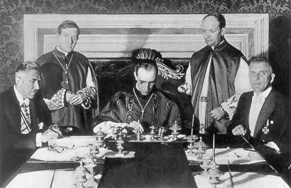 Concordate
                between Vatican and Hitler's regime of 20 July 1933 in
                Rome: Eugenio Pacelli, Minister of Foreign Affairs of
                Vatican, is signing (later he will be Pope Pius XII).
                Nazi Vice Chancellor Franz von Papen is sitting left,
                Rudolf Buttmann is sitting to the right.