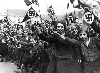 Hitler Youth: Girls with swastika
                          flags in BDM association [who does not take
                          part will kicked out]