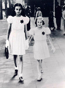 Belgium, two girls in white
                        with dark Jewish stars, Keizerlei, Antwerpen
                        1942