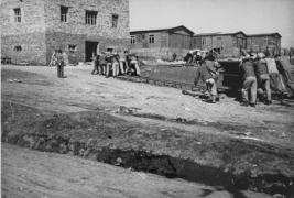 CC Plaszow (near Cracow, Poland), forced
                          labourers pushing carts filled with rocks