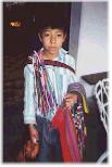 Maya natives in Guatemala:
                            boy selling articrafts in the street