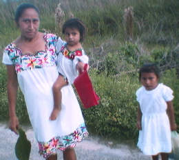 Yucatan: Maya natives with
                              traditional clothes, here mother with
                              children