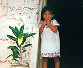 A Maya girl at an entrance
                            of a house