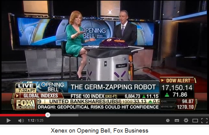 CEO Maurice Miller of XENEX company,
                            with reporter and UV light robot