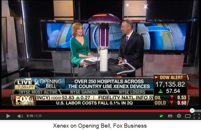 Reporter and CEO
                            Morris Miller with Xenex UV light
                            disinfection robot, final position