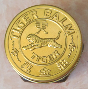 The golden
                      tap of the tiger balm glass with the toger on it