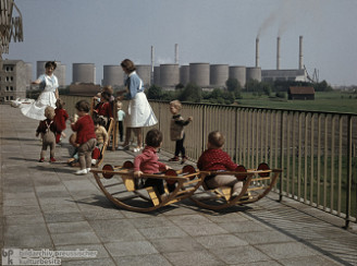 Nursery in East Germany with playing
                        apparatus next to a coal power station in
                        Vetschau